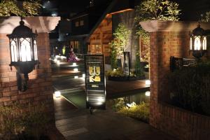 a building with a sign in the middle of a walkway with lights at Maebashi - House - Vacation STAY 64432v in Maebashi