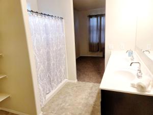 a bathroom with a sink and a shower curtain at Phoenix Comfort home II in Phoenix
