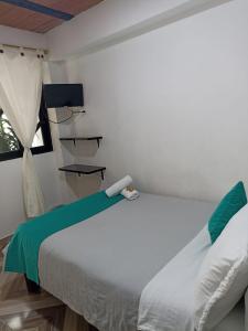 a bedroom with a white bed and a window at Hotel SAMAI in San Agustín