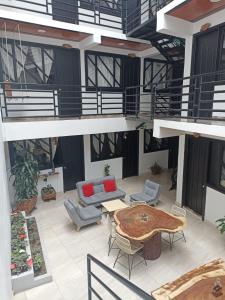 a building with a patio with a table and chairs at Hotel SAMAI in San Agustín