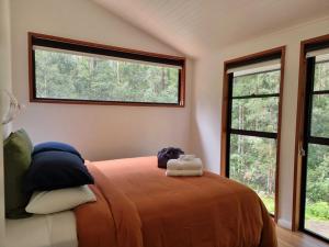 A bed or beds in a room at Carawirry Forest Escape