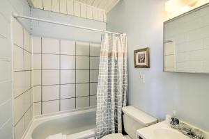 a bathroom with a shower and a toilet and a sink at Steps to Ocean Breezy Myrtle Beach Bungalow! in Myrtle Beach +28 photos
