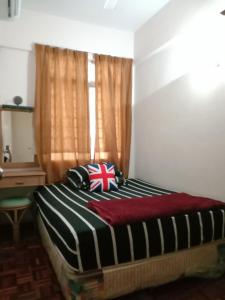 een bed in een kamer met een raam bij GLORY Beach Resort private 2 bedroom apartment in Port Dickson
