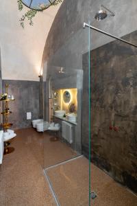 a bathroom with two sinks and a glass shower at Relais La Casa del Poeta in Gallipoli
