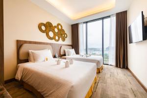 Giường trong phòng chung tại Muong Thanh Luxury Ha Long Residence