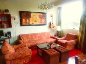 a living room with a couch and a table at Lima Backpackers in Lima