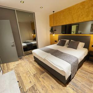 a bedroom with a large bed and a large mirror at Mangio Dubrovnik Gold in Dubrovnik