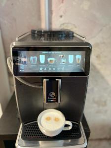 a coffee machine with a cup on top of it at Hotel Adrett am Dom in Cologne
