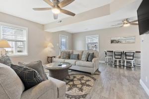 a living room with a couch and a table at Spectacular 3 BR Condo One Block to the Beach in Brigantine