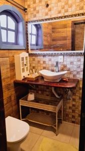 a bathroom with a sink and a toilet at Hostel Lagoa do Sol in Saquarema