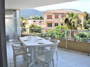 a white table and chairs on a balcony with a view at Appartement T2 avec Terrasse et Garage en Plein Centre, 4 Couchages - Cavalaire-sur-Mer - FR-1-226B-105 in Cavalaire-sur-Mer