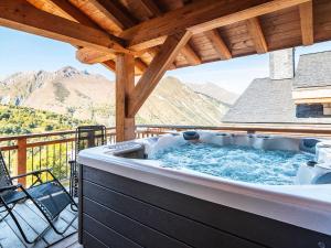 a hot tub on a deck with mountains in the background at Chalet Saint-Martin-de-Belleville, 5 pièces, 8 personnes - FR-1-344-777 in Saint-Martin-de-Belleville