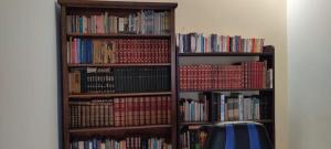 a book shelf filled with lots of books at Casa Ramirez - Guest House en el Segundo Piso in Sucre