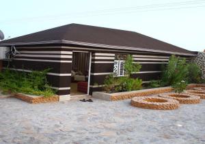 a small house with a black and white stripes at استراحة ابهار in Jadīd