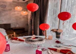 a table with red balloons and a cake on it at ابهار vip in Jadīd +29 photos