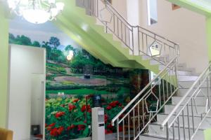 a mural of a garden on a staircase in a building at Edotel Manggala Syariah RedPartner in Sudimara