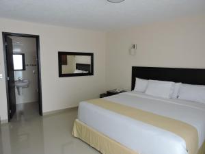 a bedroom with a large bed and a sink at Casa Jasave Hotel in Tequisquiapan