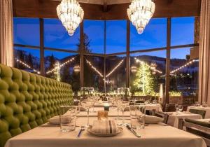 a dining room with a table with wine glasses at Slopeside 3 Bedroom Gold-rated Residence At Golden Peak Steps To Vail Village in Vail