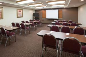 una sala de conferencias con mesas, sillas y una pantalla en AmericInn by Wyndham Thief River Falls, en Thief River Falls 34 fotos más
