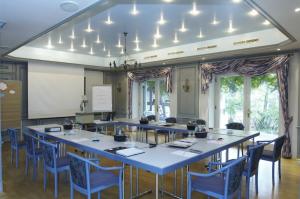 a large meeting room with a large table and chairs at Freimühle Hotel-Restaurant in Girod