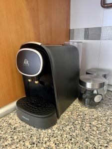 a black coffee maker sitting on a counter at Plaza Mayor ATUAIRE in Burgos