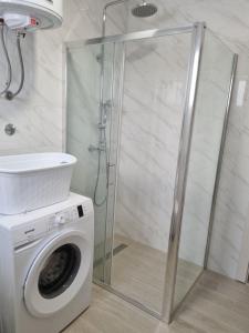 La salle de bains est pourvue d'une douche et d'un lave-linge. dans l'établissement Apartman Marko, à Šibenik