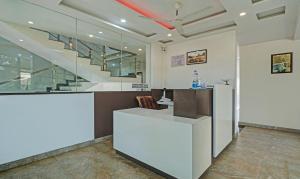 an office with a white counter and a staircase at Itsy By Treebo - Vijaya Comforts, Coorg in Madikeri