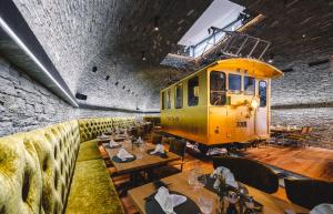 a restaurant with a yellow train on the wall at Hotel Tannenhof in Zermatt