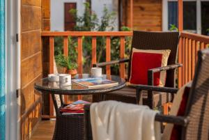 a table and two chairs on a porch at Mariners Bay Beach Resort in Arambol