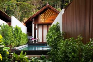 a house with a swimming pool in a garden at The Tubkaak Krabi Boutique Resort in Tab Kaek Beach