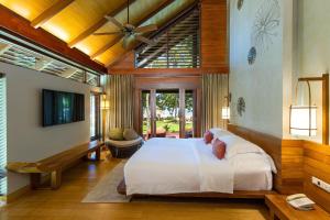 a bedroom with a large white bed in a room at The Tubkaak Krabi Boutique Resort in Tab Kaek Beach