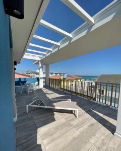 a patio with a bench on a roof at MAR60 Apartments in Caorle