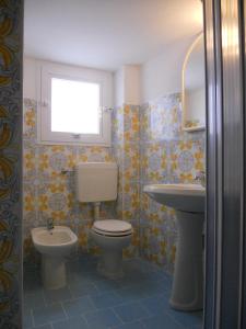 a bathroom with a toilet and a sink at Appartamenti Iacono in Forio d'Ischia +16 photos