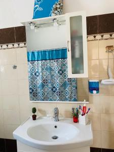 a bathroom with a sink and a mirror at Mikro Amoni Beach Villa in Pefkali +72 photos