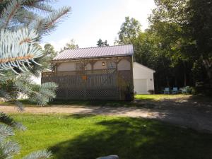 ein kleines Haus mit einem Tor im Hof in der Unterkunft Skyline Cabins in Ingonish