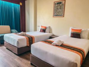 Postel nebo postele na pokoji v ubytování Neo Hatyai Hotel