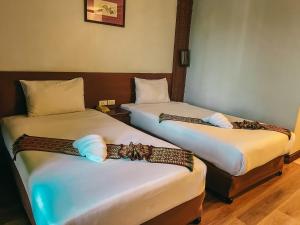 Postel nebo postele na pokoji v ubytování Neo Hatyai Hotel
