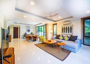 a living room with a couch and a table at Laguna Park Townhomes & Villas in Bang Tao Beach