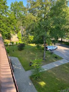 a park with a car parked in a parking lot at Apartamentai Palangos Centre in Palanga
