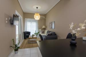 a living room with a couch and a table at APT 48, COZY APARTMENT IN KALAMATA CITY CENTER in Kalamata