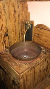 a wooden sink with a faucet on top of it at La Bergerie du Plateau in Cros-de-Géorand