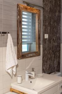 a bathroom with a sink and a mirror at Aquamarine House in Tivat +56 photos
