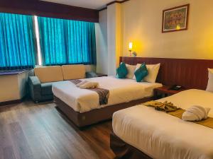 Postel nebo postele na pokoji v ubytování Neo Hatyai Hotel