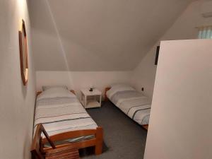 a room with two beds in a room with a wall at Holiday Home near Lake and Volcano Area in Nemesgulács
