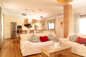 uma sala de estar com um sofá branco e uma mesa em Casa La Loma de Arenas em Arenas
