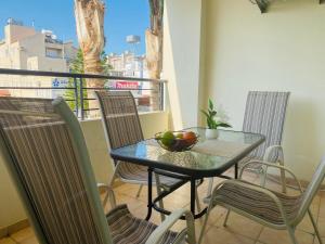 a table with a bowl of fruit on a balcony at Apollo 2-BR Apt in Larnaca in Larnaca
