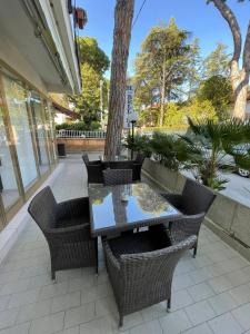 a patio with a table and wicker chairs at Hotel Bellini in Riccione