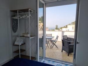 a room with a view of a table and chairs at Romy Blu in Capri +54 photos