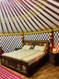 a bedroom with a king sized bed in a igloo at The Glamping Spot Kalam in Kalām