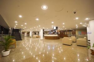 a lobby with chairs and a reception desk in a building at Bigmall Residency in Kānnangād